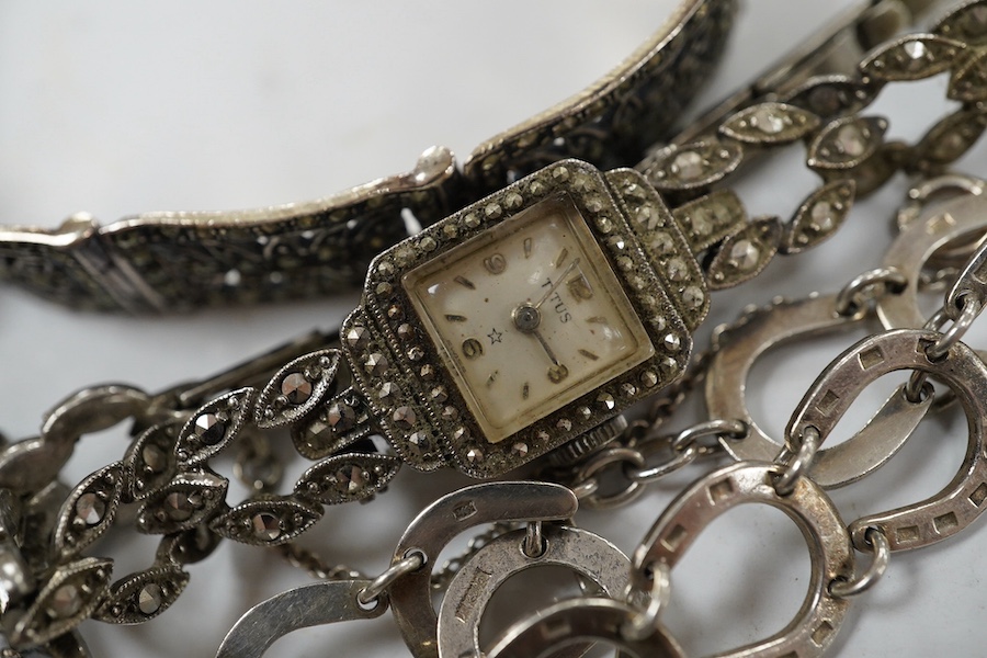 Two silver bracelets, a silver watch chain, a silver and marcasite bracelet and a similar watch. Condition - fair